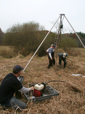 Collecting 10-foot vibracores in a marsh