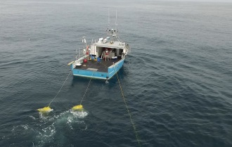 Encourager underway towing side scan and magnetometer sensors using drogue bouys to limit speed